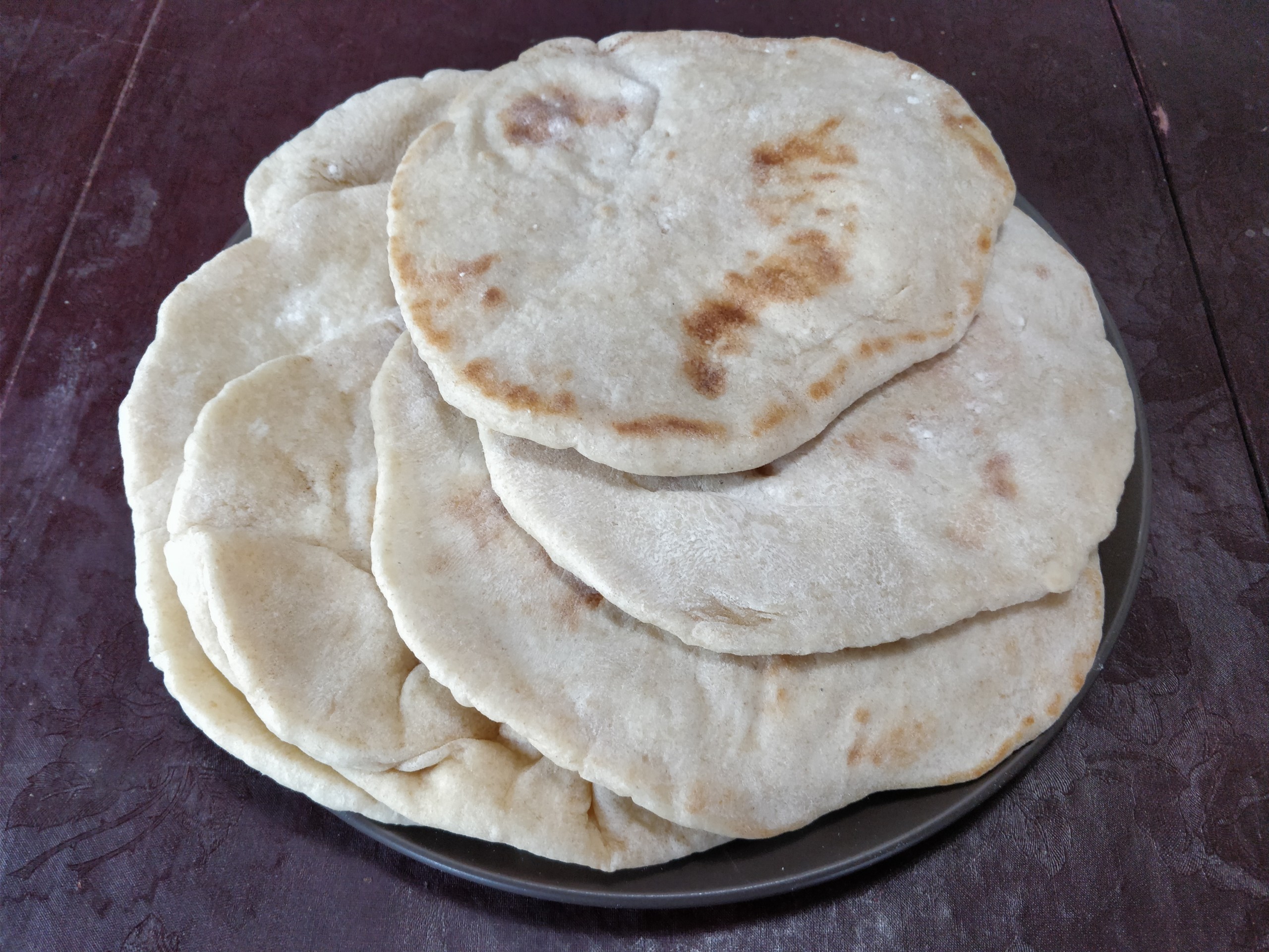 Pita breads stacked on a plate