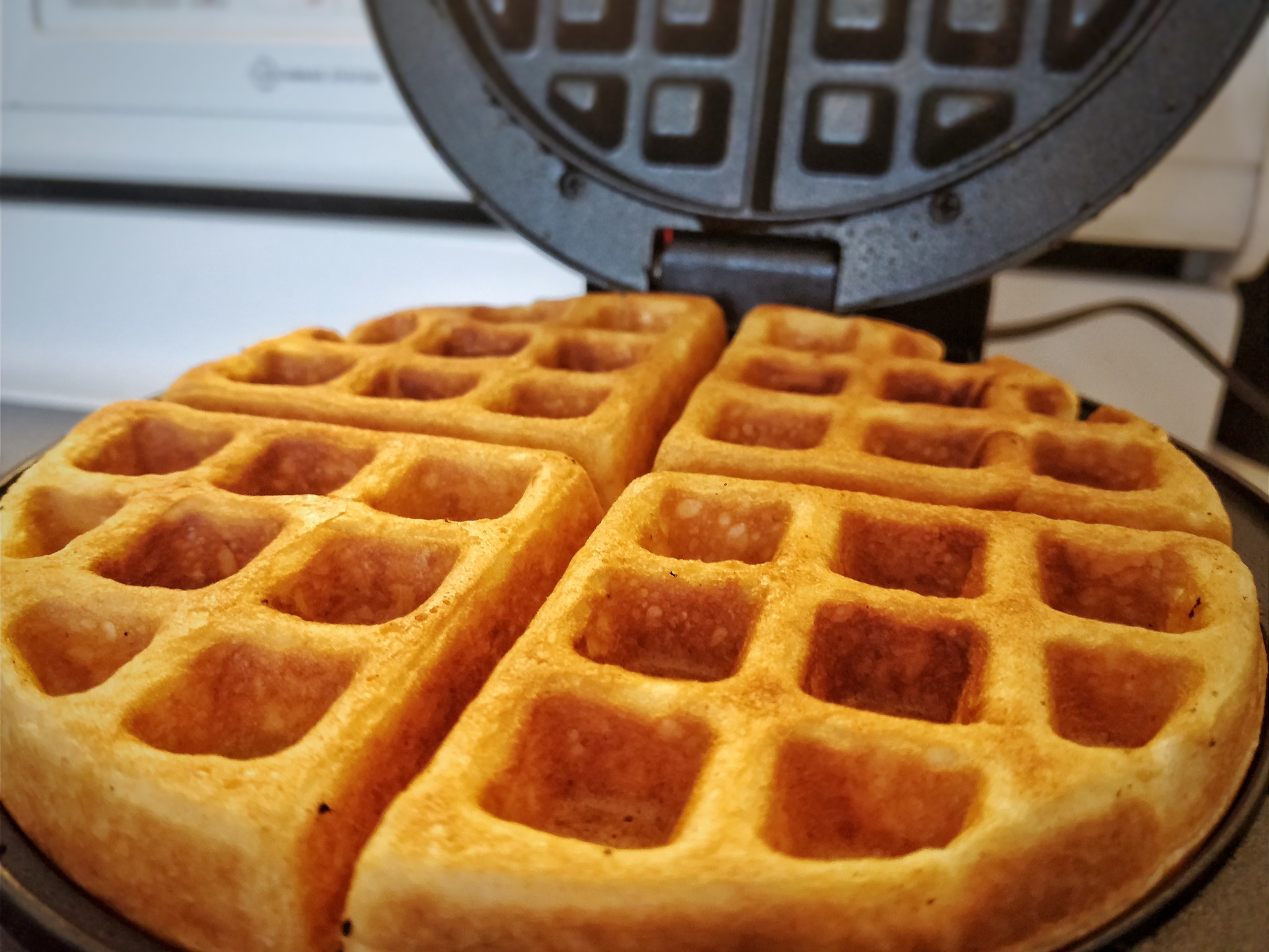 Fresh cooked waffle in the open waffle iron.