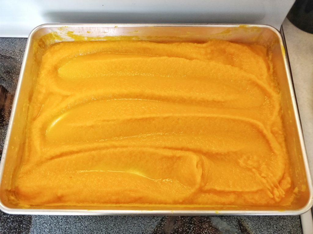 Pumpkin puree spread out in a baking sheet