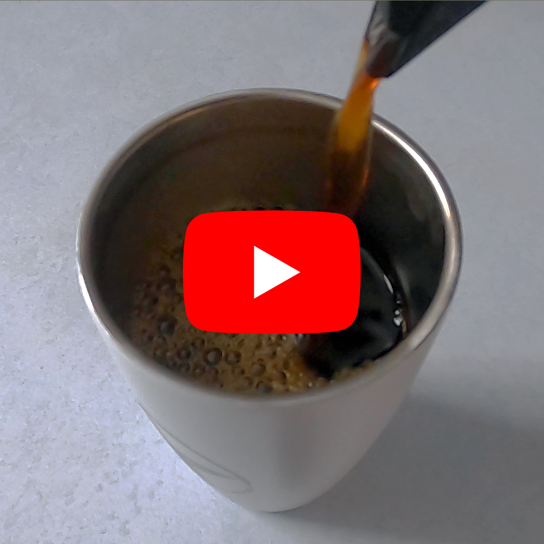 Coffee pouring into a cup with the YouTube logo in front
