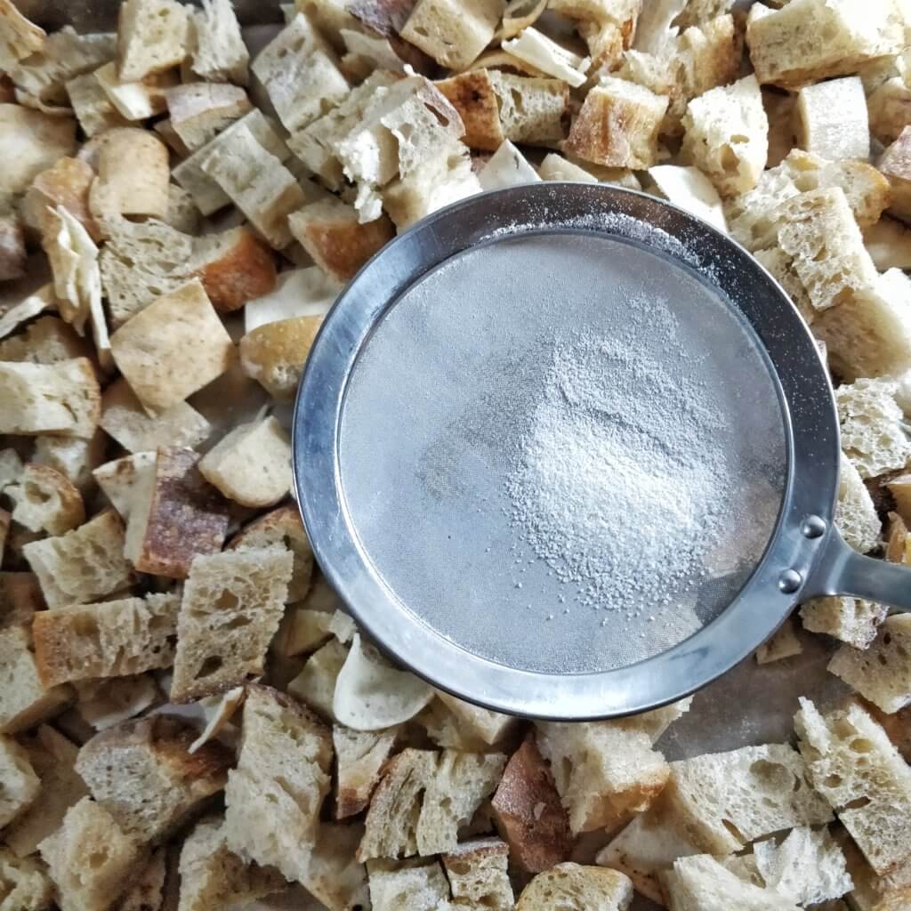 Koji spores mixed with rice flour spread over the bread with a sifter.