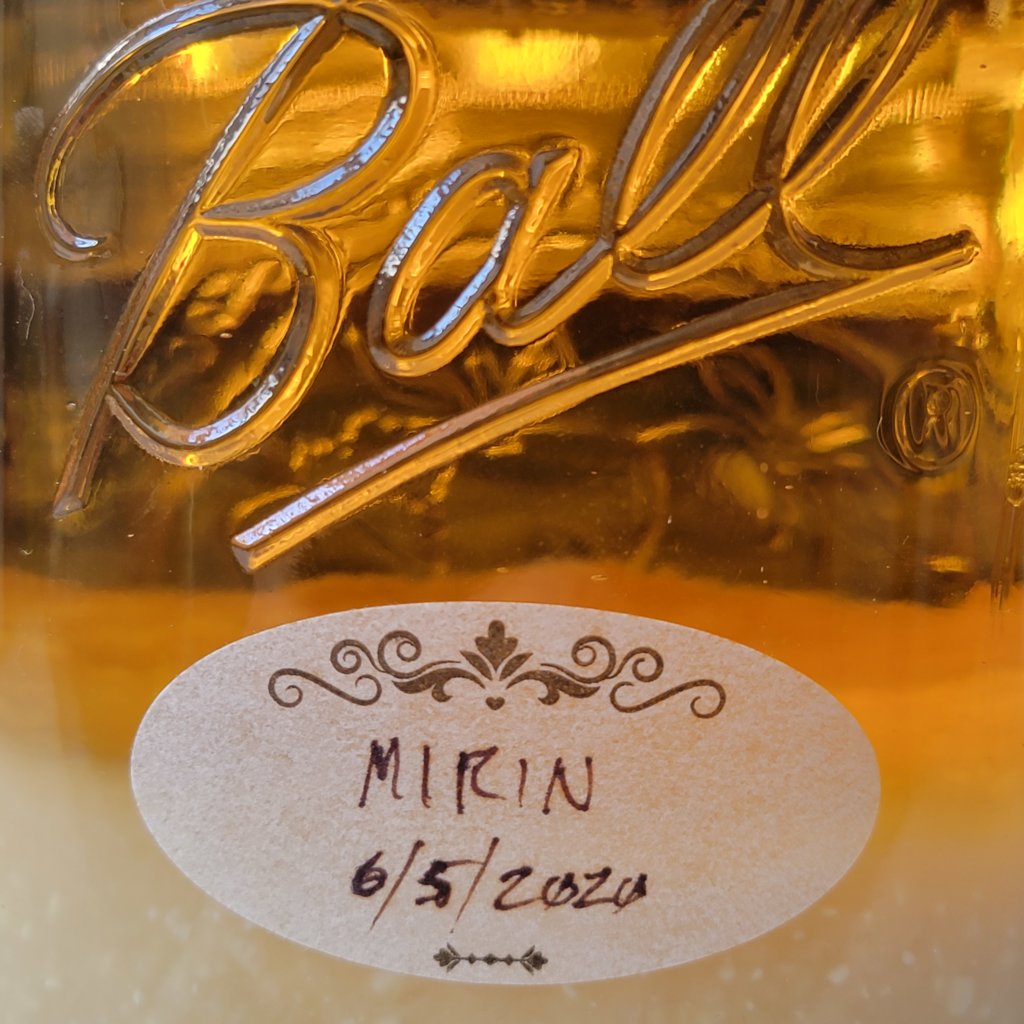 Closeup of the mirin jar revealing a deep amber color, like rich honey.