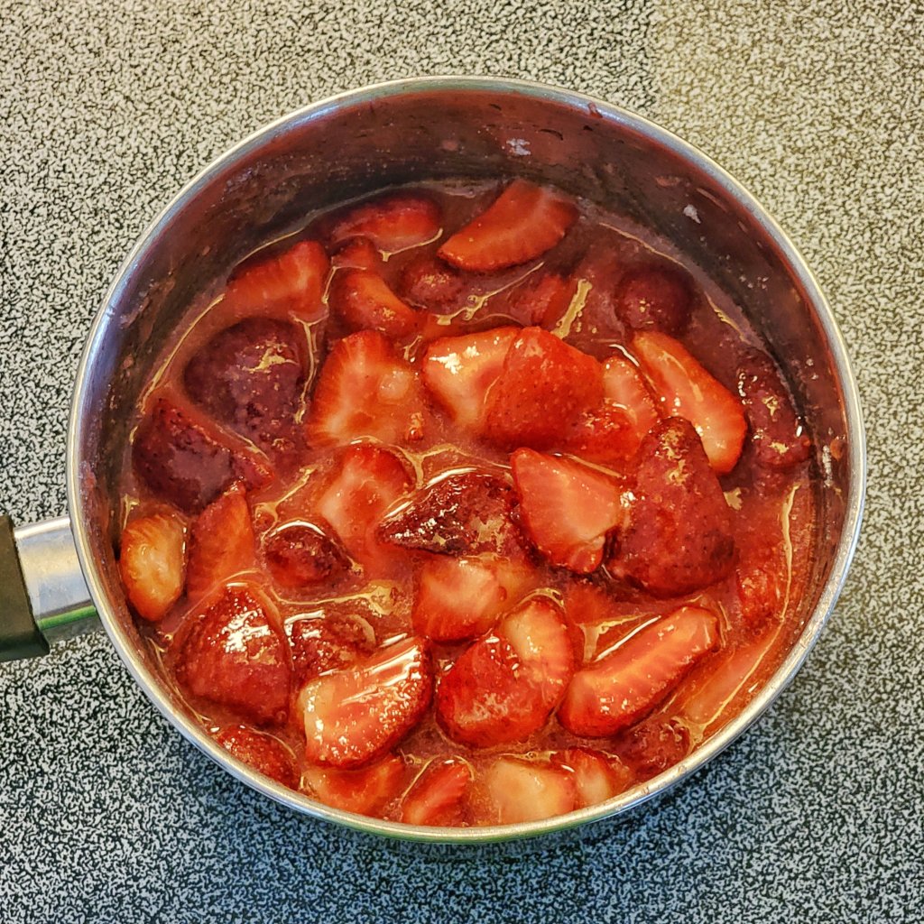 Strawberries have started to masticate, looking syrupy and glossy.