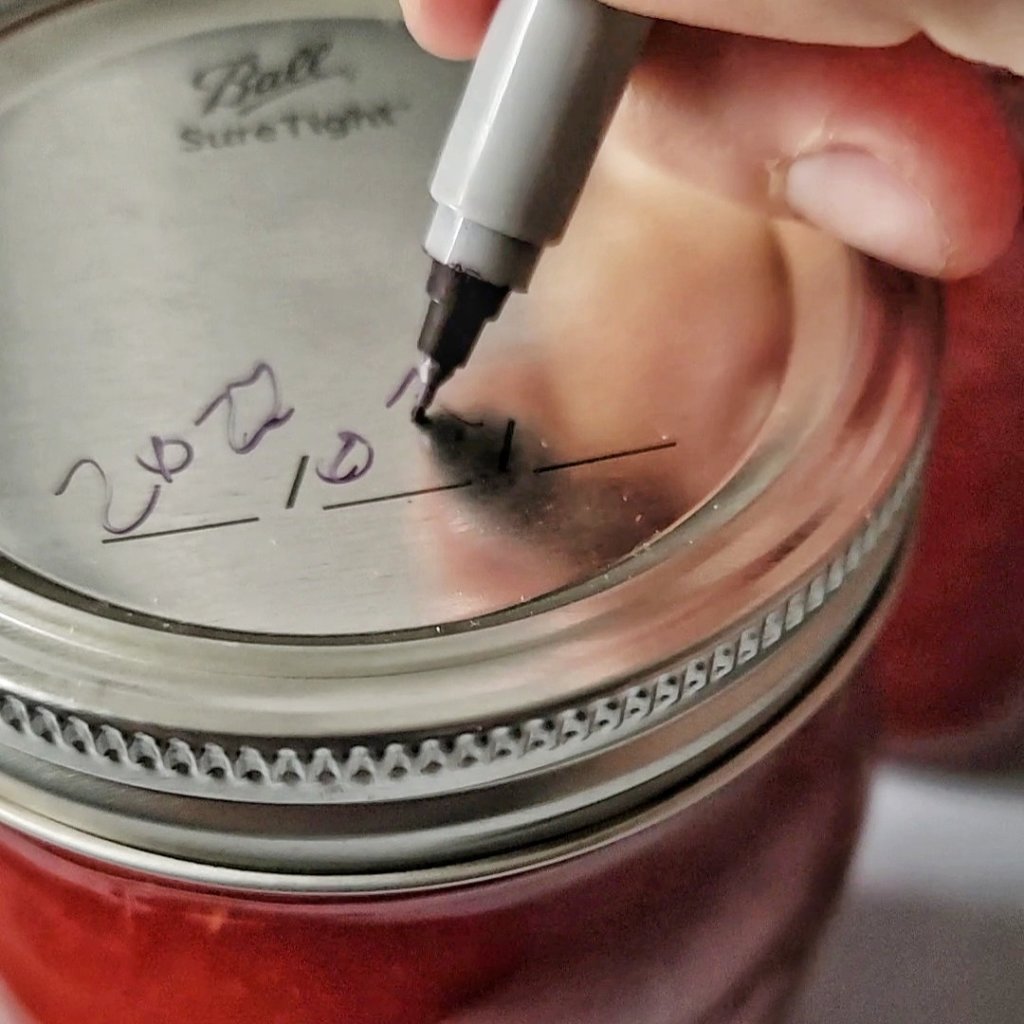 Closeup of writing date on the lid with a fine-point permanent marker.