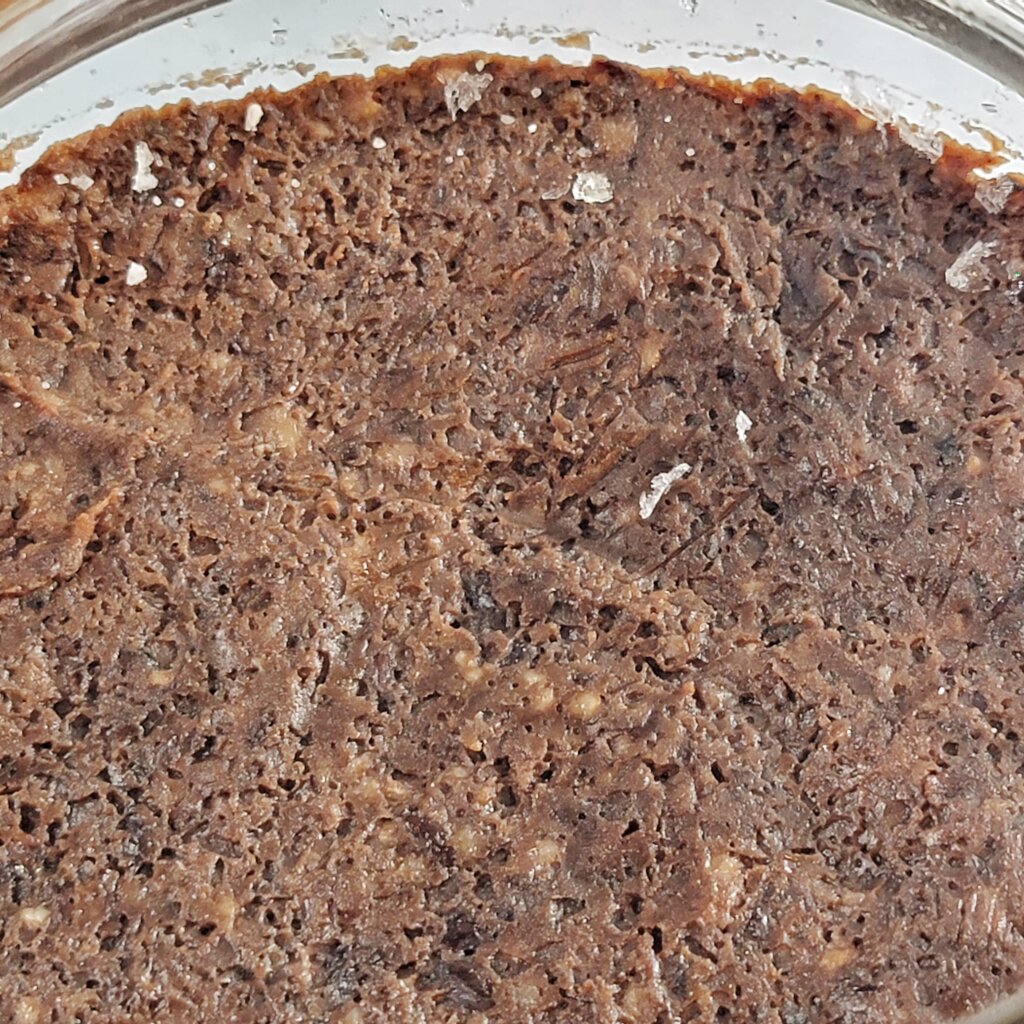 Closeup of the top of the miso. It is pockmarked with little holes from bubbles that formed right under the clingfilm.