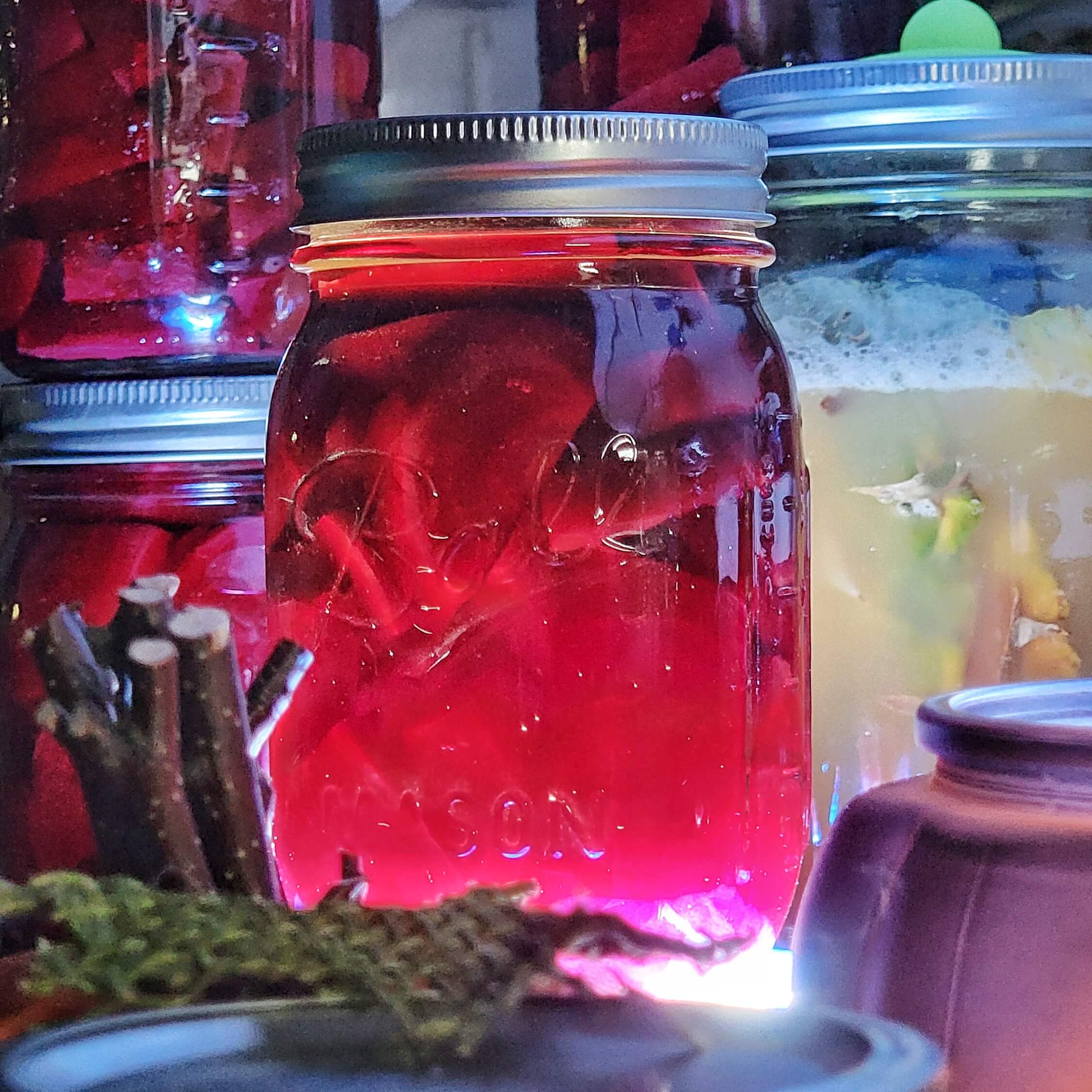 Ominous sliced beets in a jar lit from below.